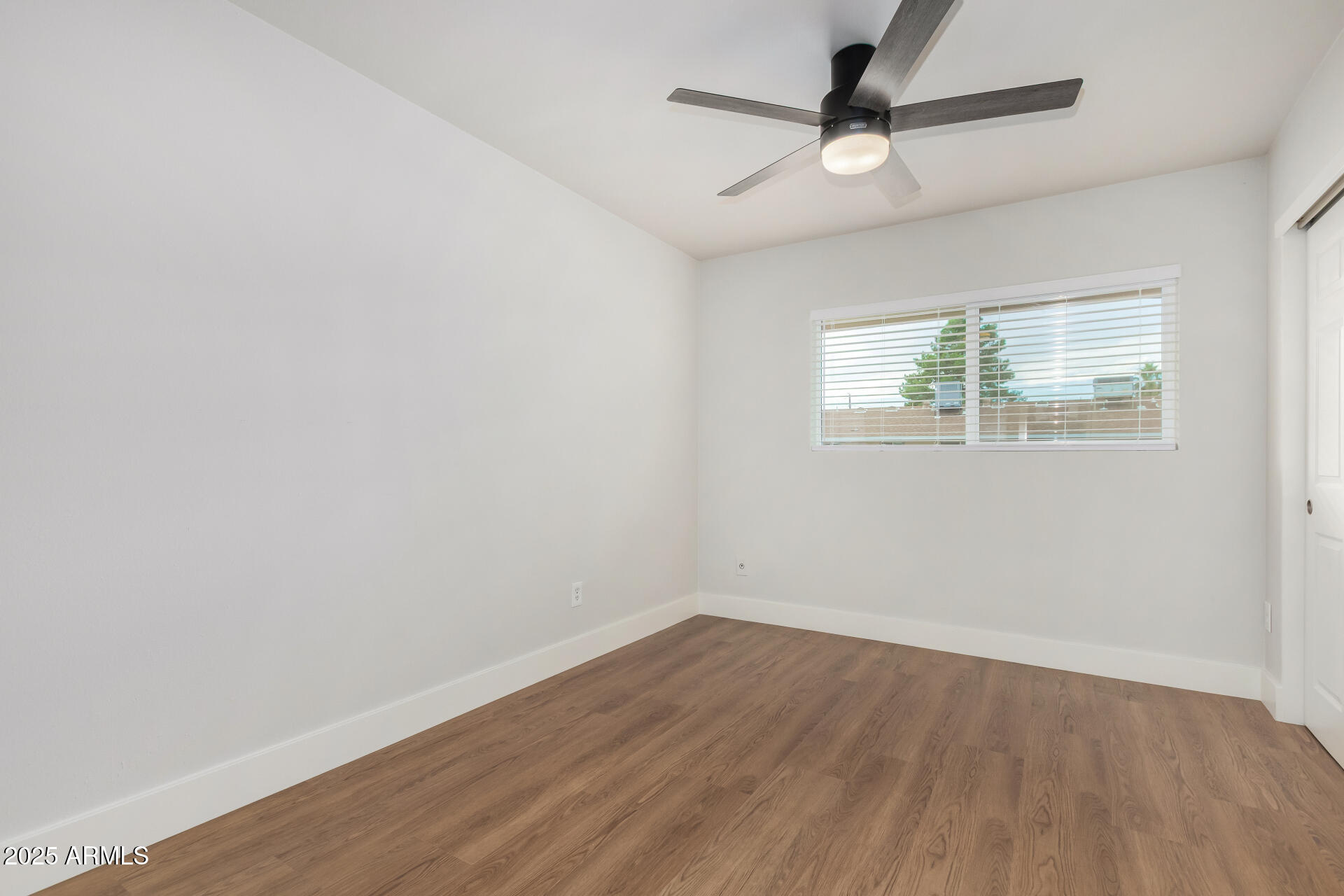 6027 North Granite Reef Road Scottsdale, AZ 85250 - Photo 14 of 29 wooden floor in an empty room with a window