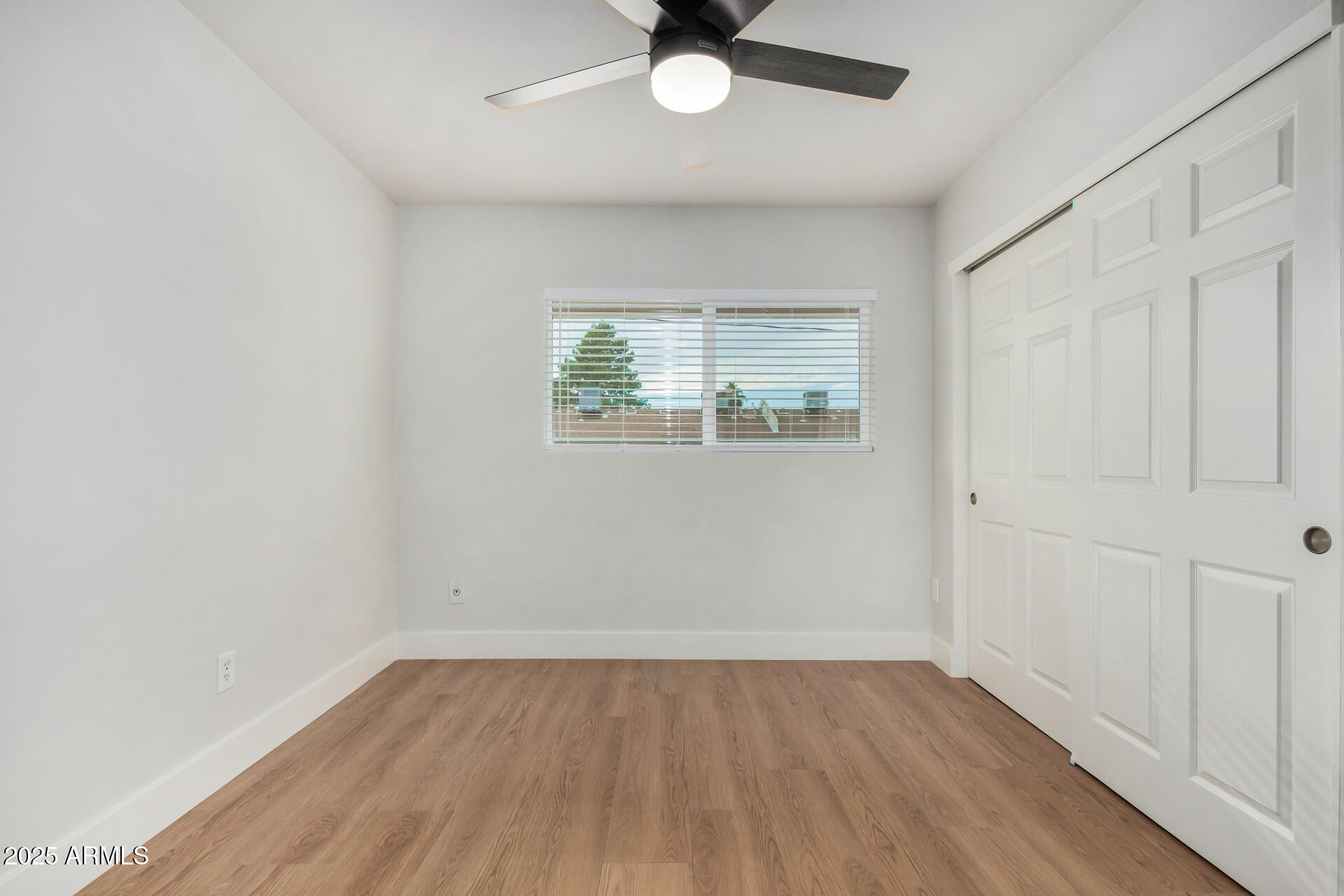 6027 North Granite Reef Road Scottsdale, AZ 85250 - Photo 15 of 29 an empty room with wooden floor and windows