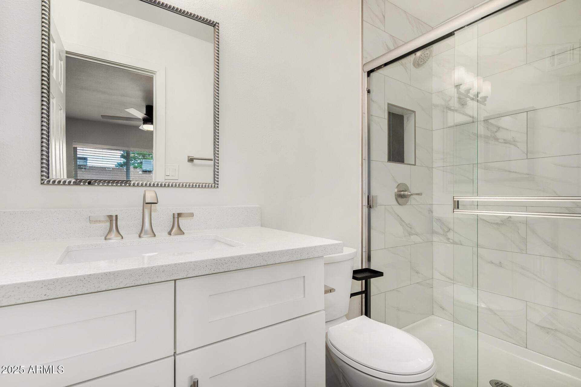 6027 North Granite Reef Road Scottsdale, AZ 85250 - Photo 17 of 29 a bathroom with a sink a toilet and shower