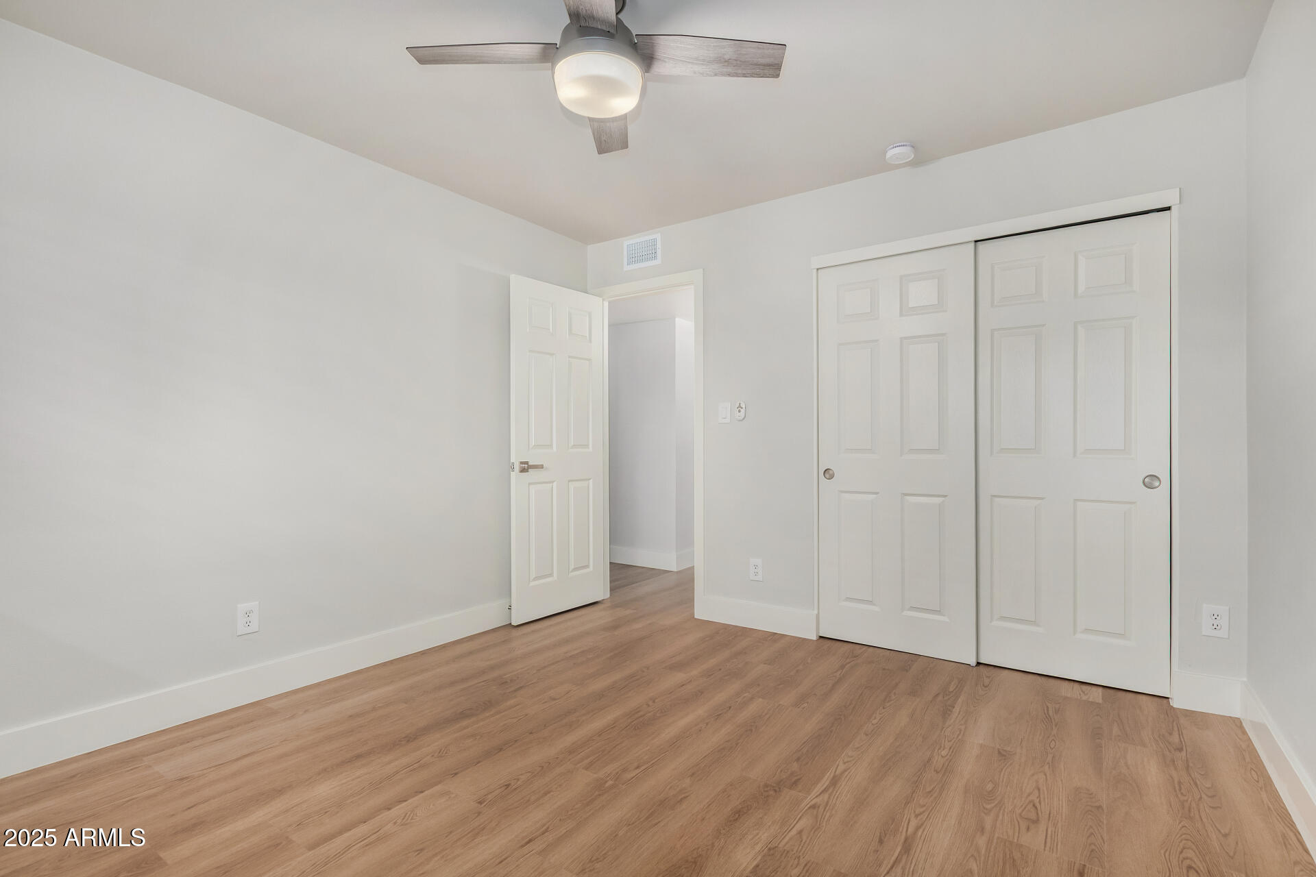 6027 North Granite Reef Road Scottsdale, AZ 85250 - Photo 18 of 29 an empty room with wooden floor and windows