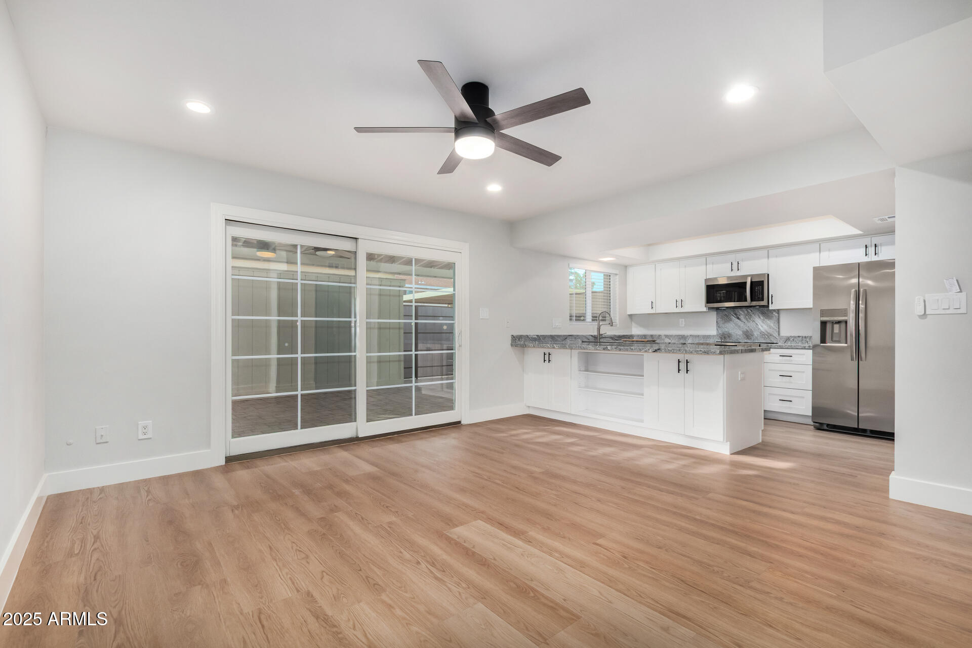 6027 North Granite Reef Road Scottsdale, AZ 85250 - Photo 5 of 29 a view of kitchen with granite countertop cabinets and refrigerator
