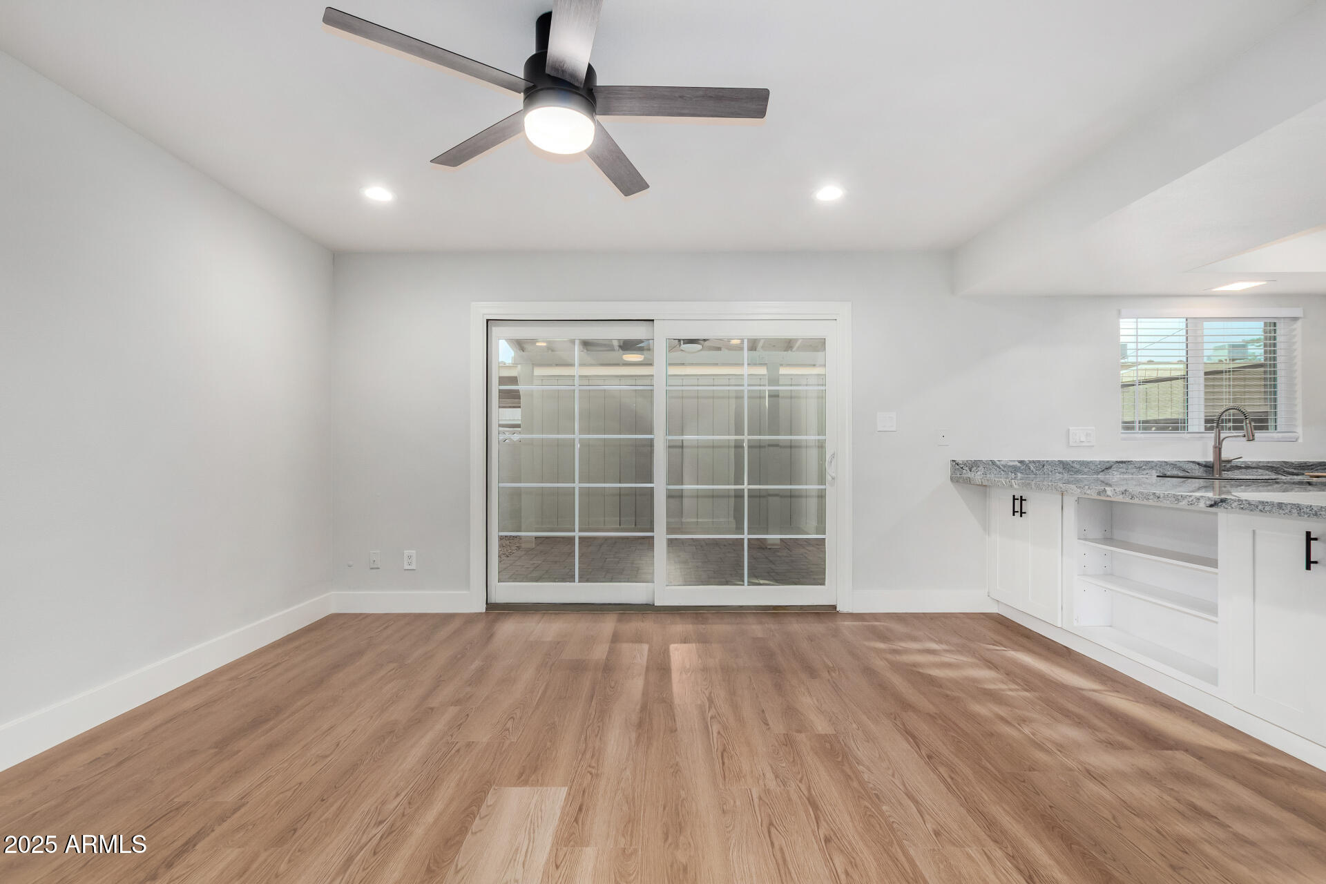 6027 North Granite Reef Road Scottsdale, AZ 85250 - Photo 6 of 29 a view of an empty room with a window and wooden floor