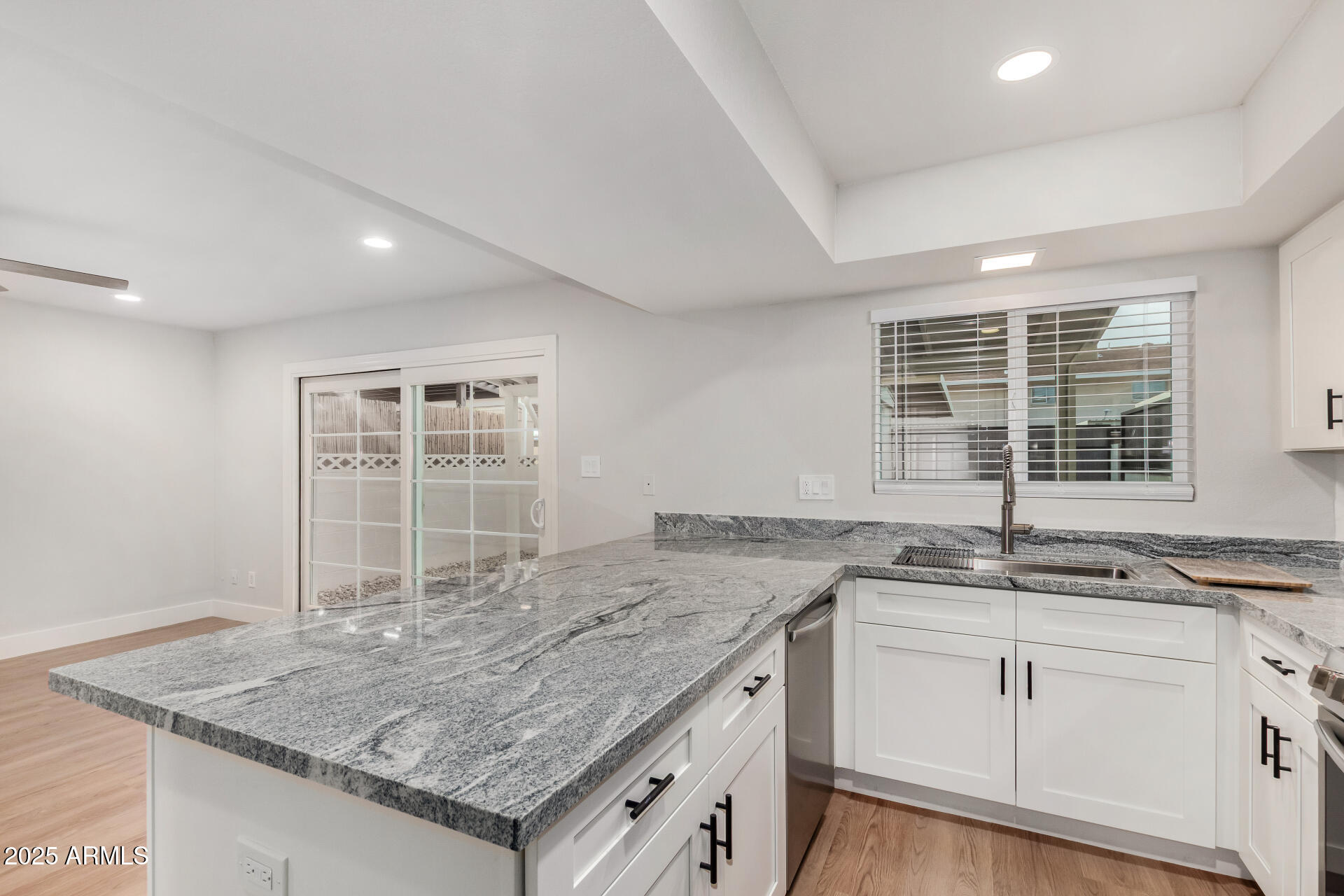 6027 North Granite Reef Road Scottsdale, AZ 85250 - Photo 9 of 29 a kitchen with granite countertop a sink and a window