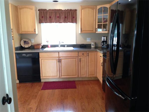 27 Boston Road Sutton, MA 01590 - Photo 4 of 17 a kitchen with granite countertop a refrigerator sink and cabinets