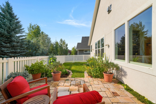 1238 Canyon View Road Midway, UT 84049 - Photo 25 of 33 Stone patio with a white picket fence and surrounding greenery
