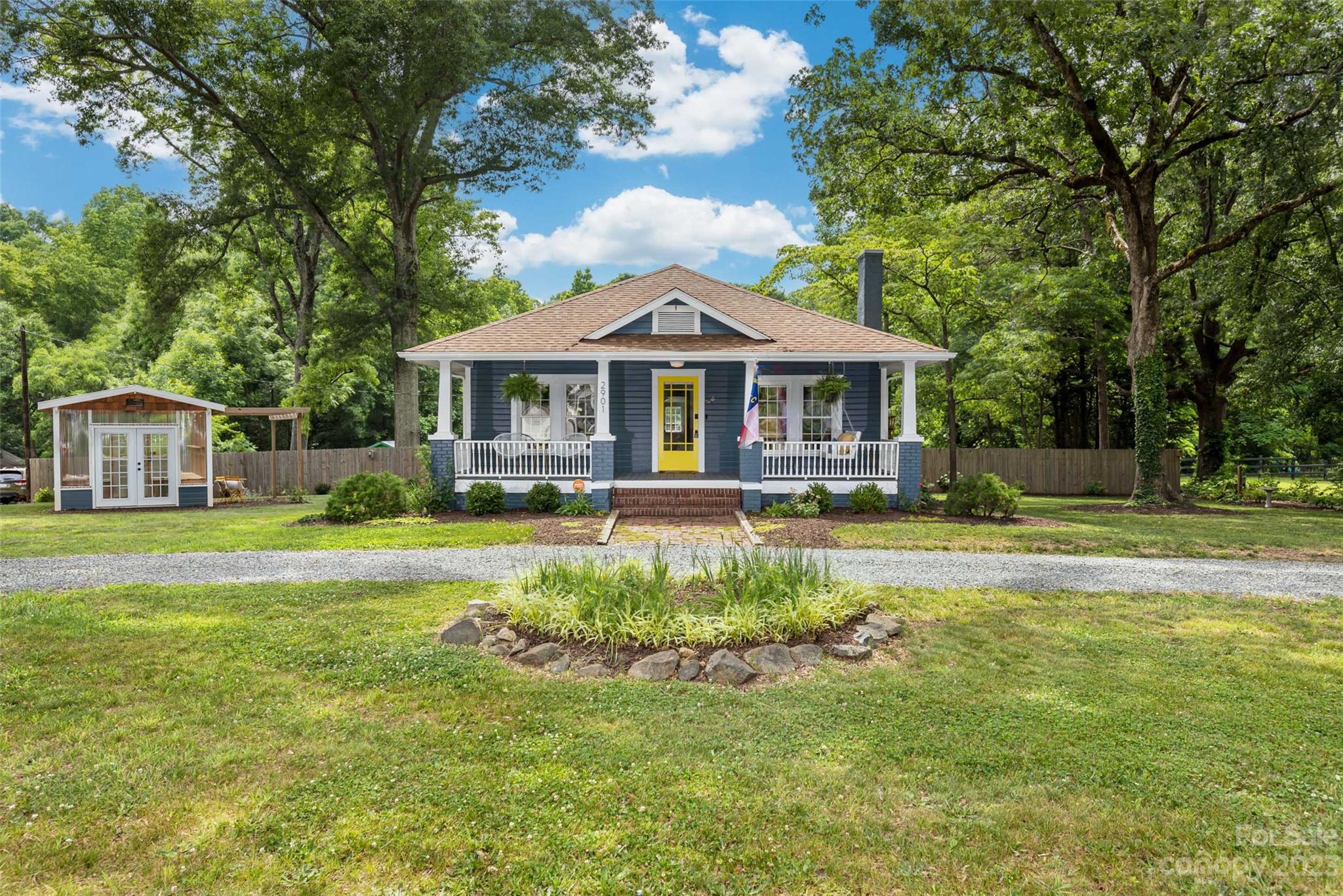 a front view of a house with swimming pool having outdoor seating