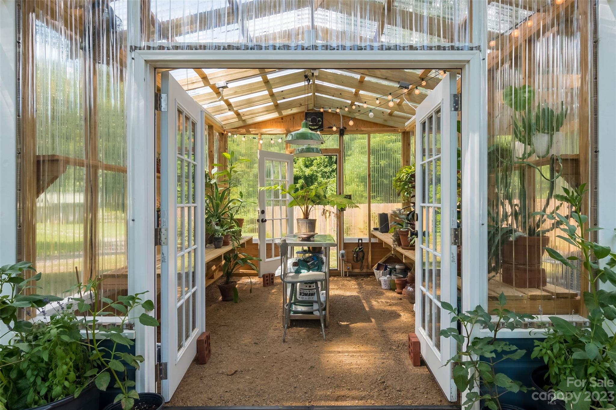 2901 Oakdale Road Charlotte, NC 28216 - Photo 29 of 48 a view of a porch with chairs and floor to ceiling window