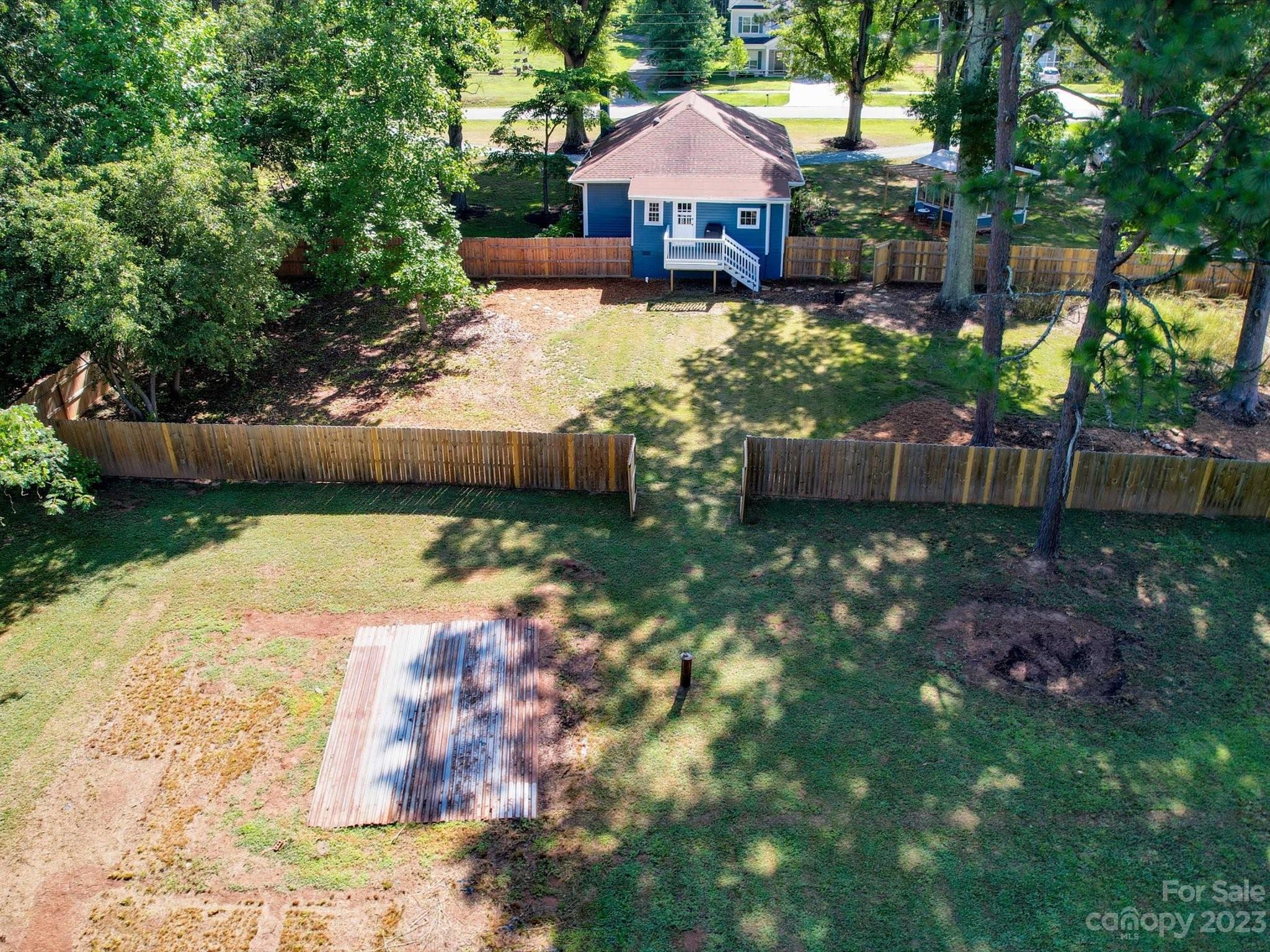 2901 Oakdale Road Charlotte, NC 28216 - Photo 43 of 48 a view of a swimming pool with lawn chairs under an umbrella
