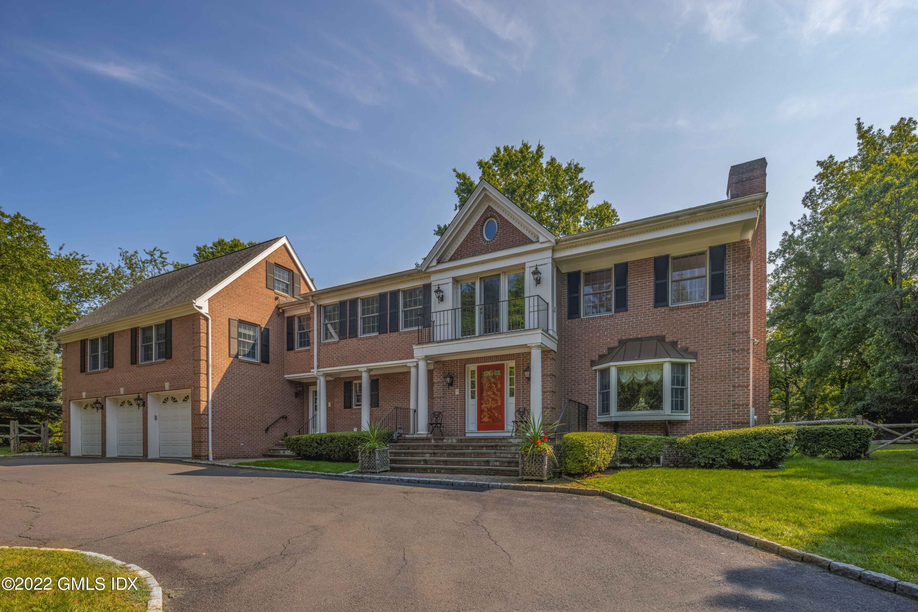 42 Angus Lane Greenwich, CT 06831 - Photo 2 of 39 a front view of a house with a garden