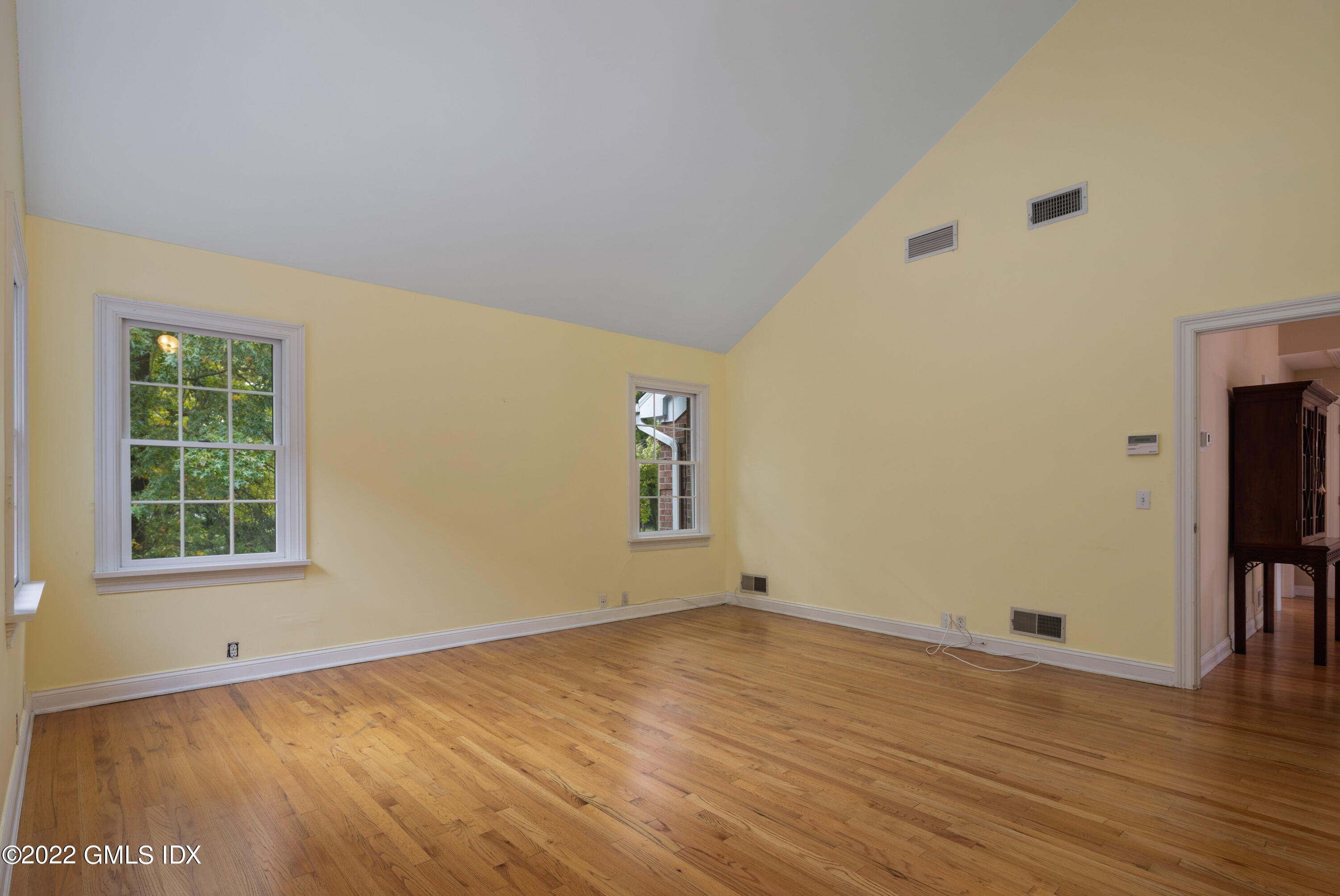42 Angus Lane Greenwich, CT 06831 - Photo 24 of 39 an empty room with wooden floor and windows