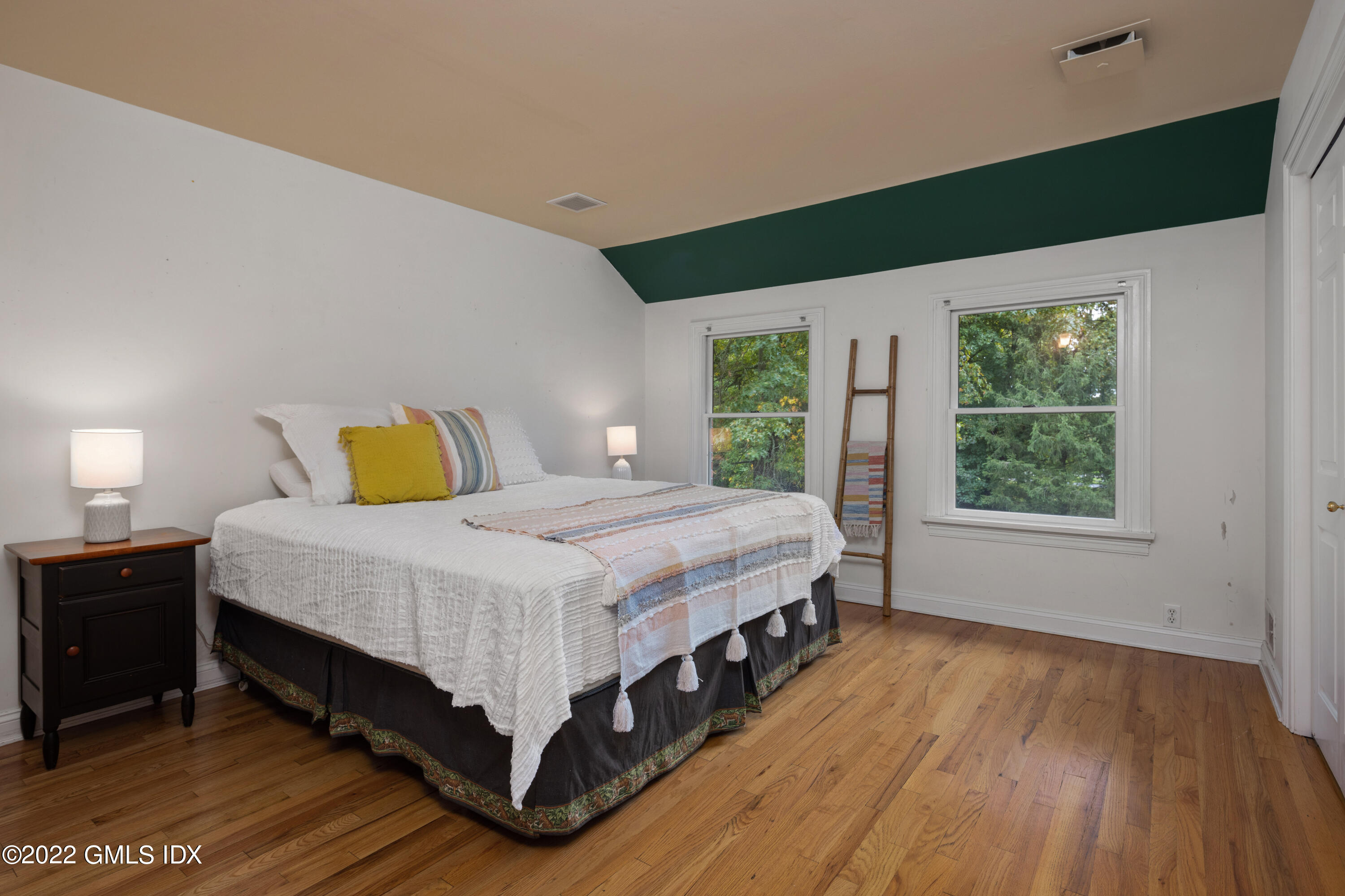 42 Angus Lane Greenwich, CT 06831 - Photo 25 of 39 a spacious bedroom with a bed and wooden floor