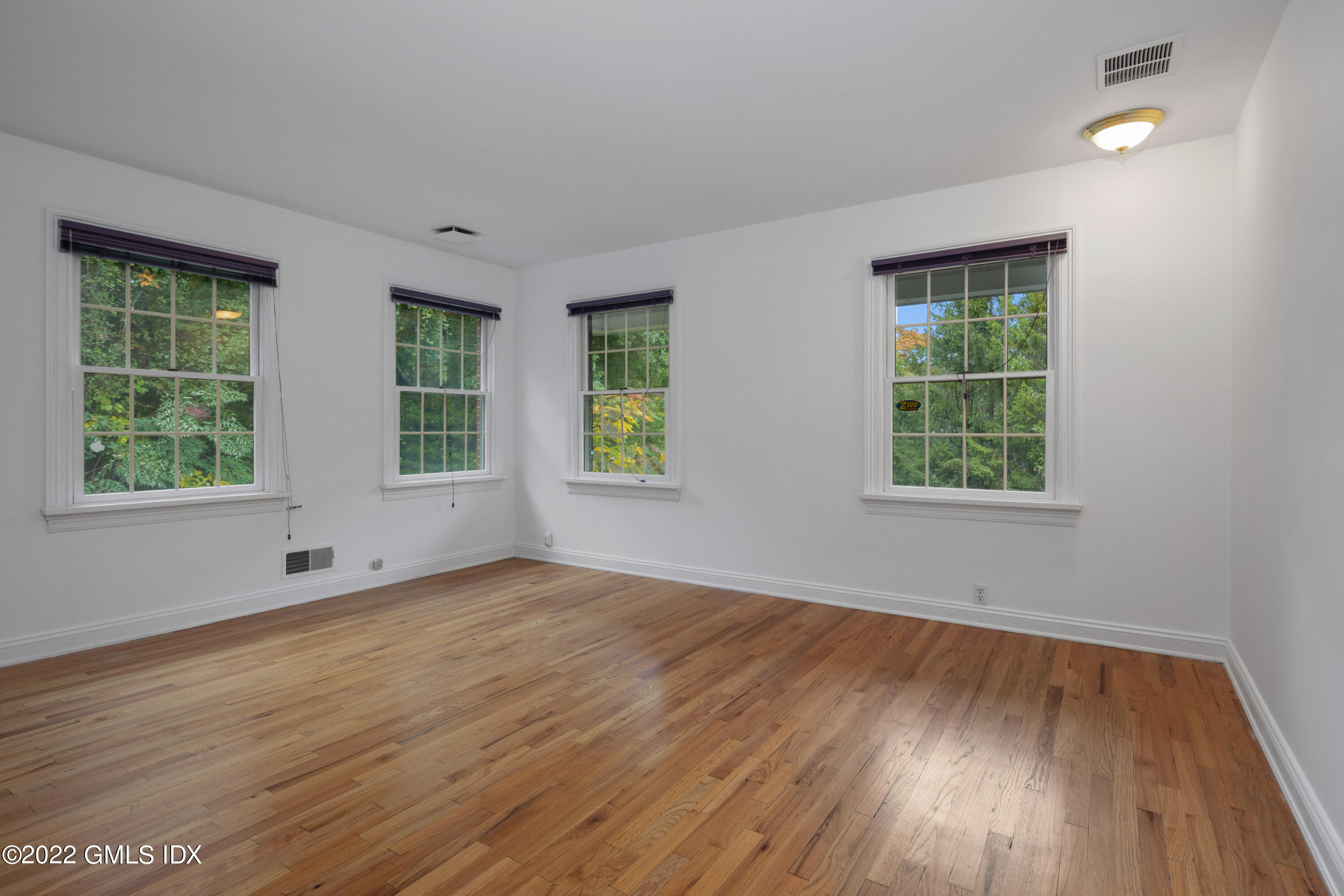 42 Angus Lane Greenwich, CT 06831 - Photo 27 of 39 an empty room with wooden floor and windows