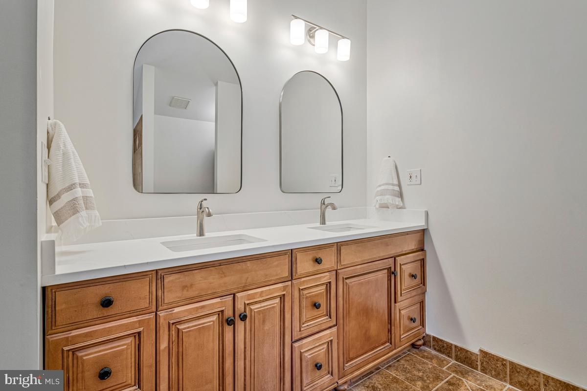 1410 Dent Road Shady Side, MD 20764 - Photo 19 of 42 Elegant dual-sink bathroom retreat.