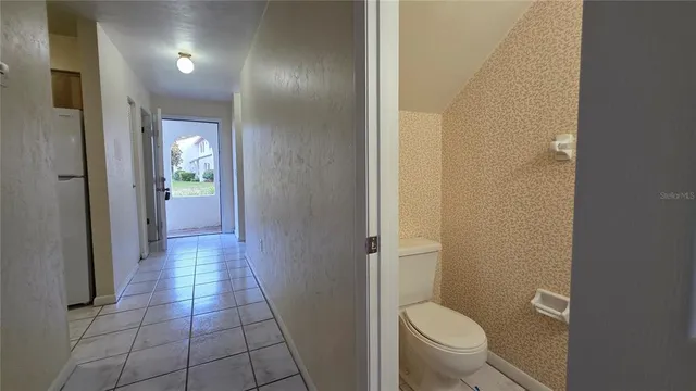 a bathroom with a granite countertop toilet and a sink