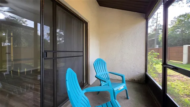 a view of a room with furniture and wooden floor
