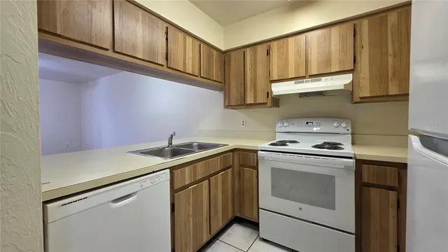 a kitchen with stainless steel appliances granite countertop a sink and cabinets