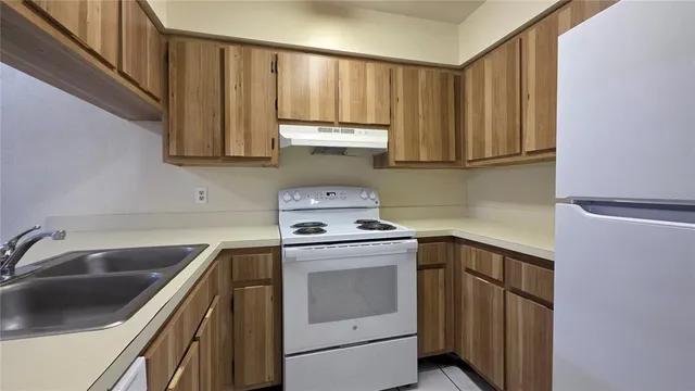 a kitchen with a sink stove and cabinets