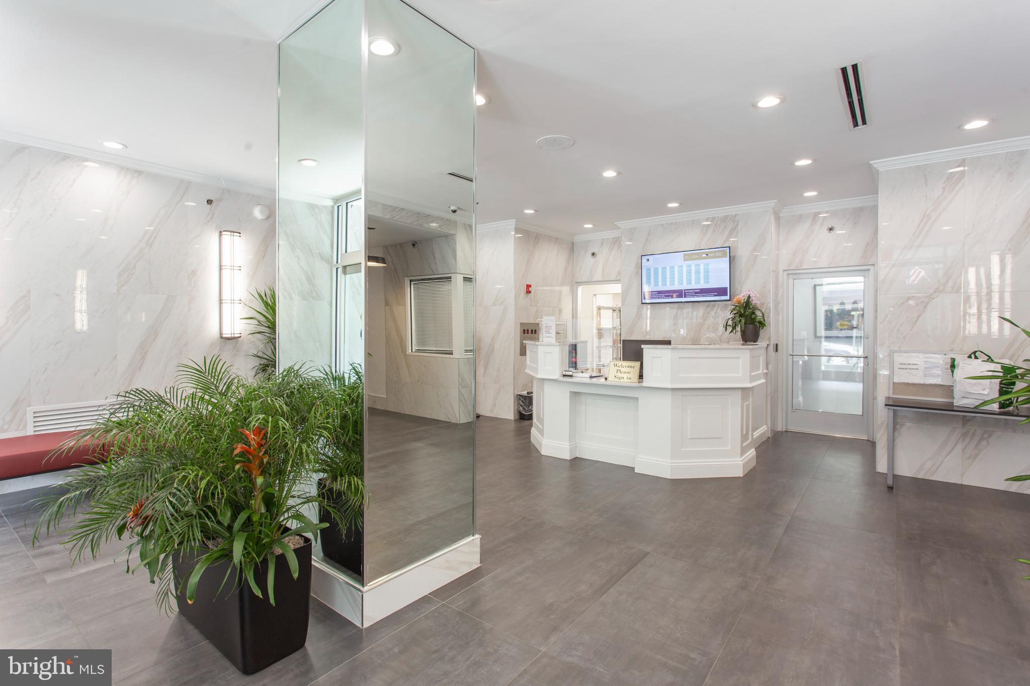 2101-17 Chestnut Street, Unit 215 Philadelphia, PA 19103 - Photo 5 of 10 a large kitchen with white cabinets and a stainless steel appliances
