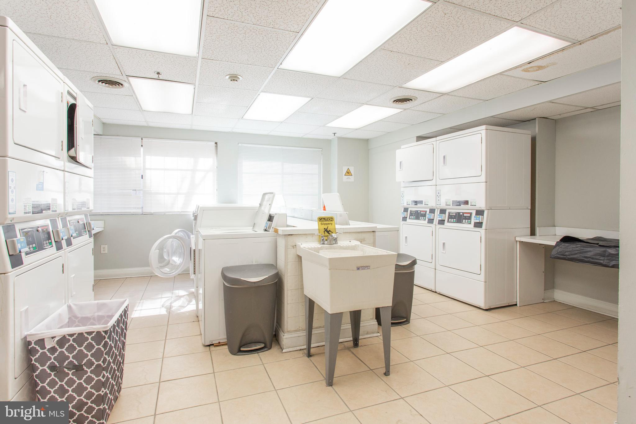 2101-17 Chestnut Street, Unit 215 Philadelphia, PA 19103 - Photo 8 of 10 a kitchen with cabinets and chairs