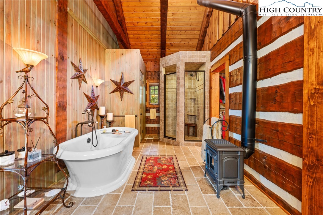 333 Windy Ridge Road Vilas, NC 28692 - Photo 21 of 46 a bathroom with a sink and mirror with bathtub