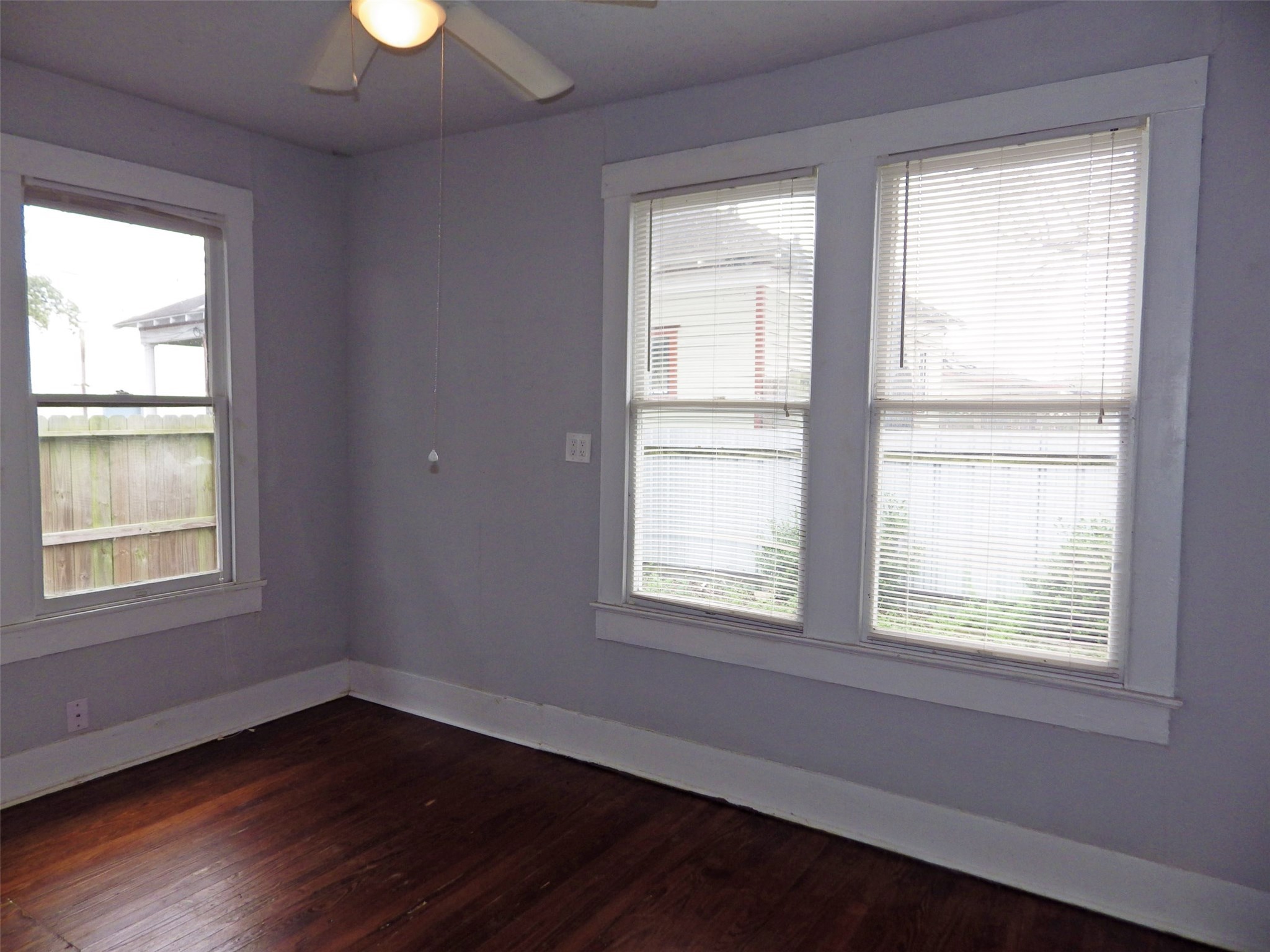 4322 Wilmer Street Houston, TX 77003 - Photo 12 of 31 a view of an empty room with wooden floor and a window
