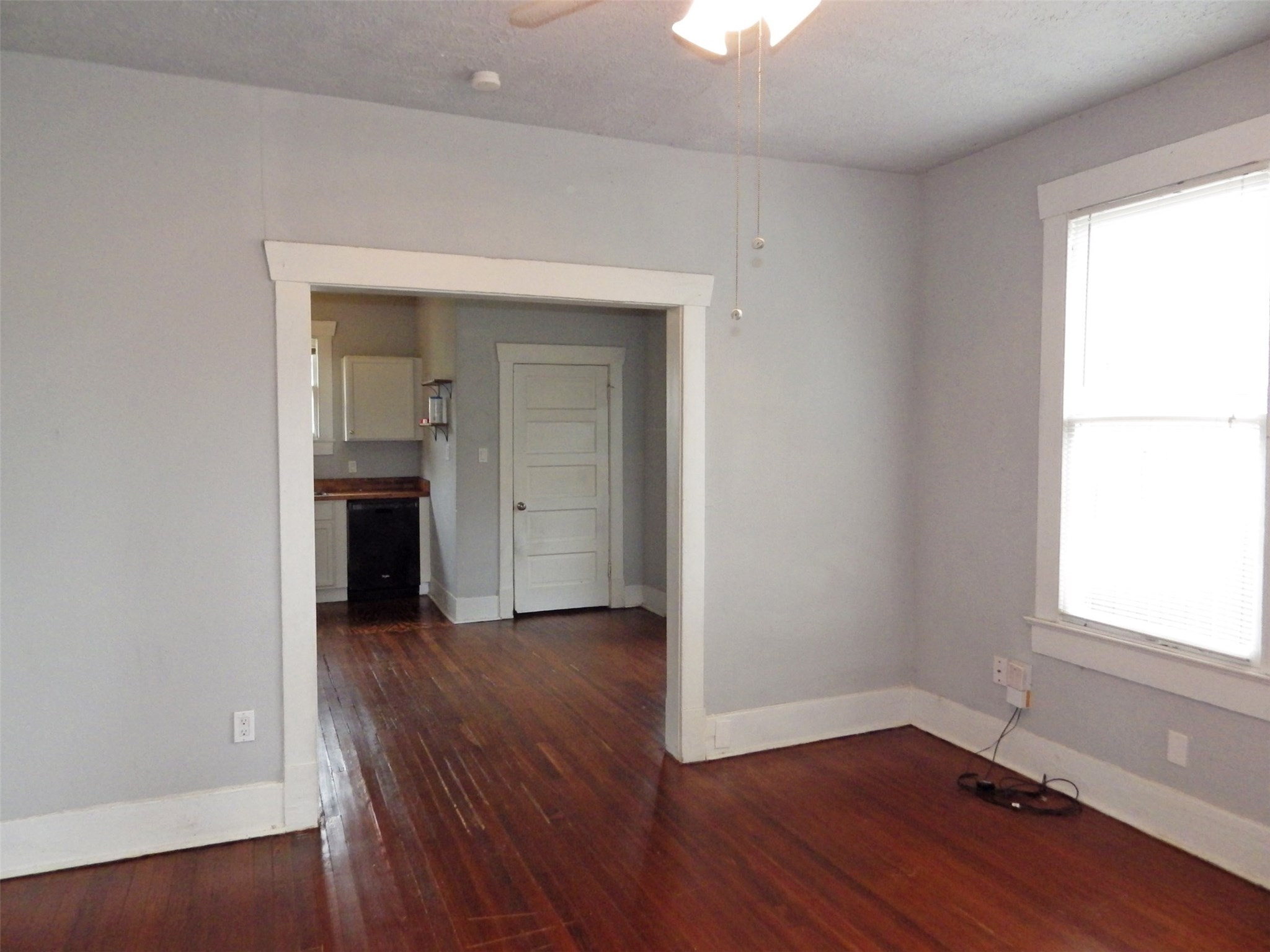 4322 Wilmer Street Houston, TX 77003 - Photo 3 of 31 an empty room with wooden floor cabinet and windows