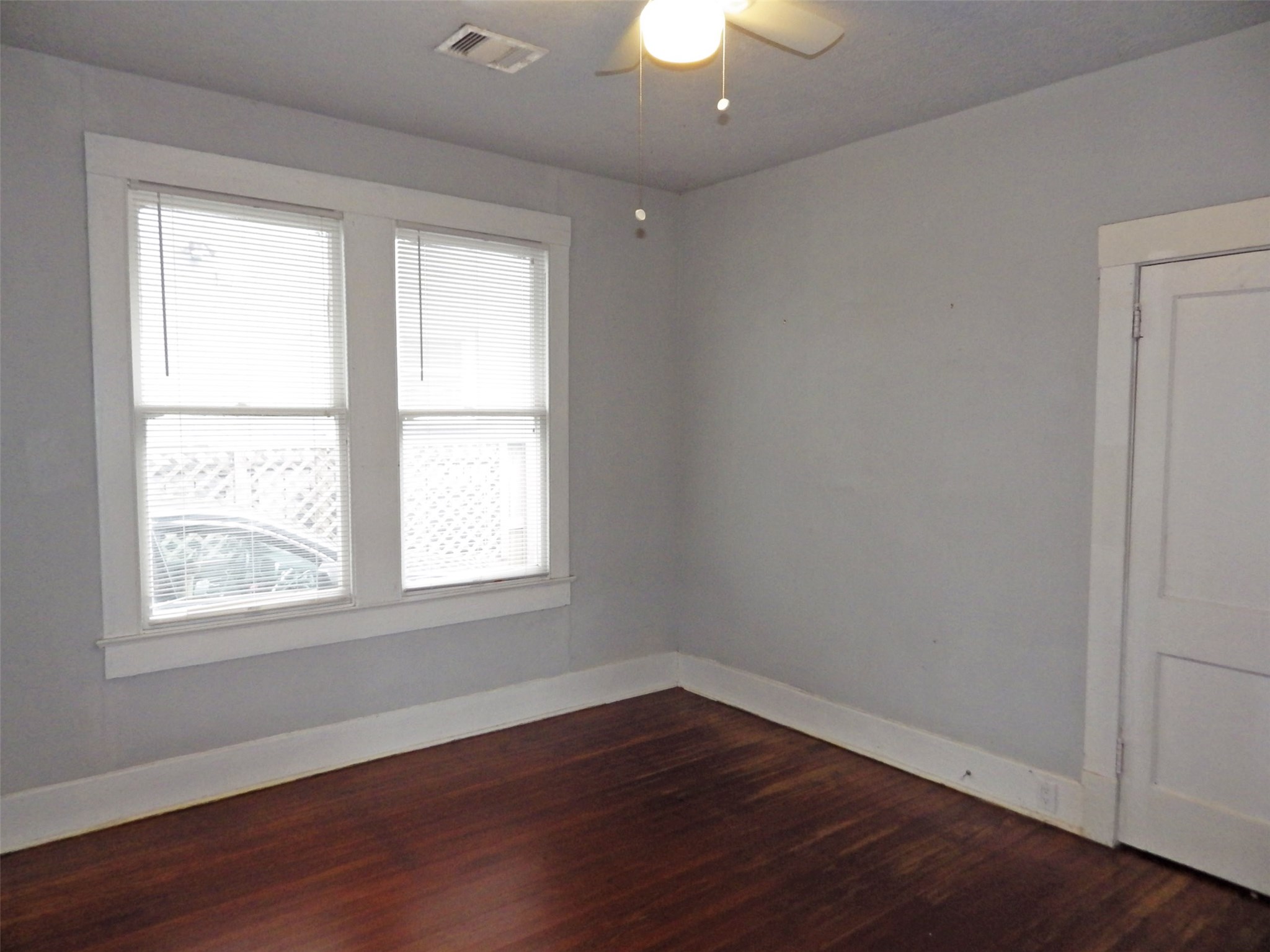 4322 Wilmer Street Houston, TX 77003 - Photo 8 of 31 an empty room with wooden floor and windows