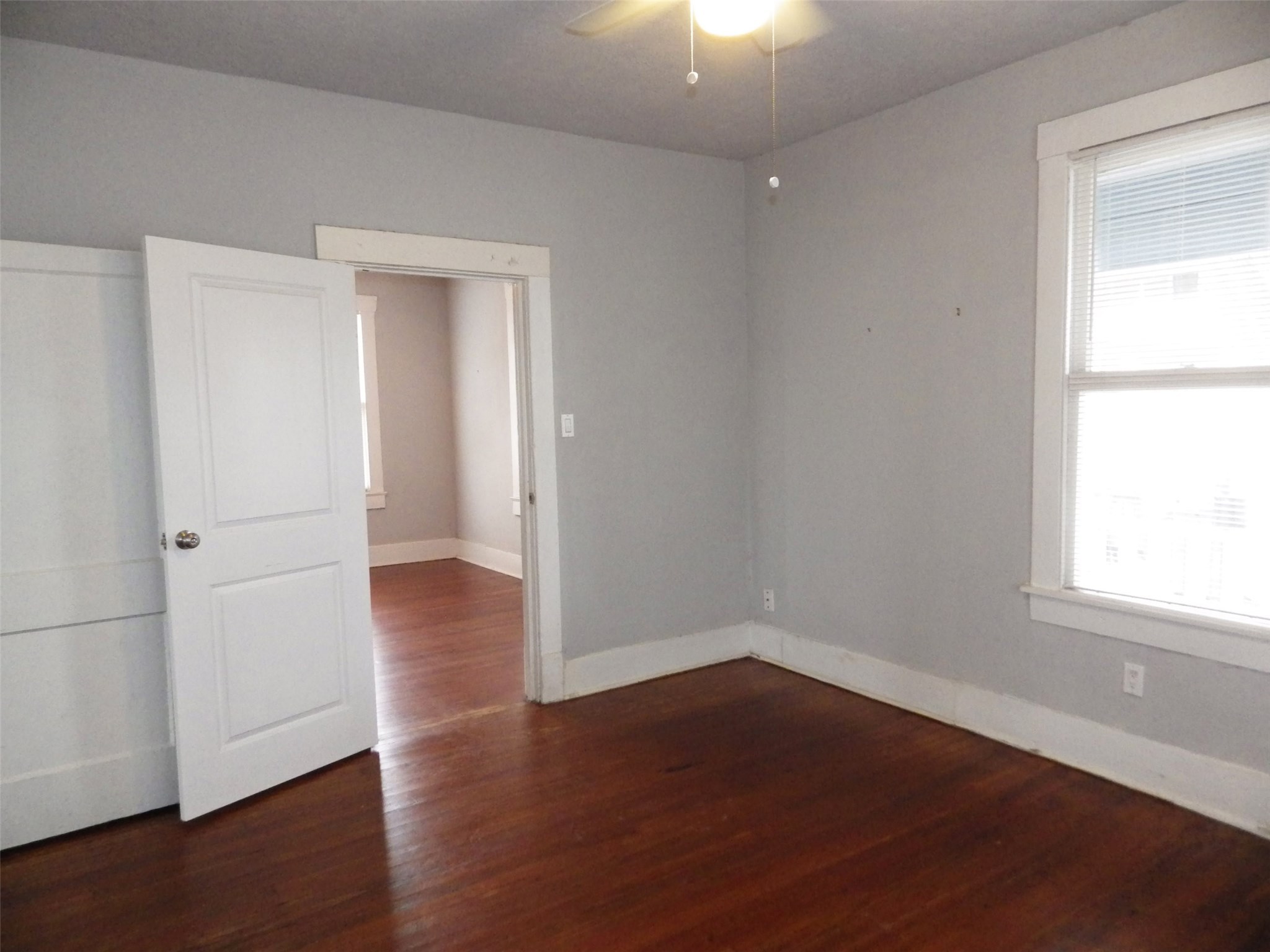 4322 Wilmer Street Houston, TX 77003 - Photo 10 of 31 an empty room with wooden floor cabinet and windows