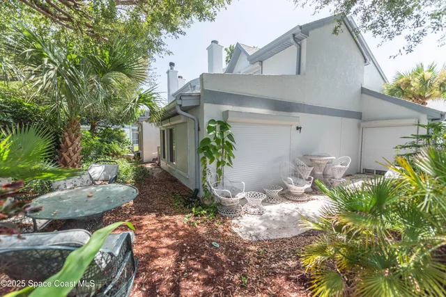 a view of a house with yard and sitting area