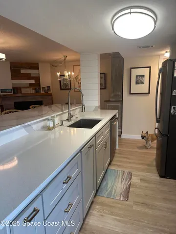 a spacious bathroom with double vanity and a mirror