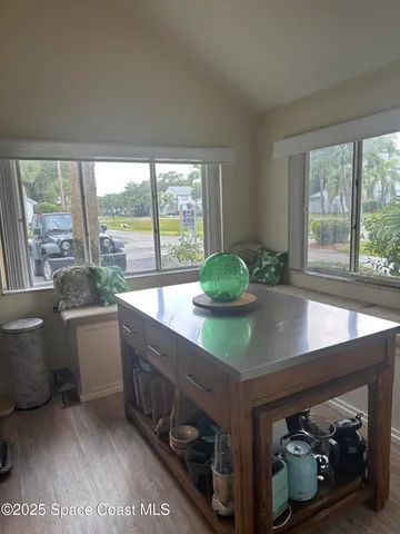 a kitchen with a sink and large window