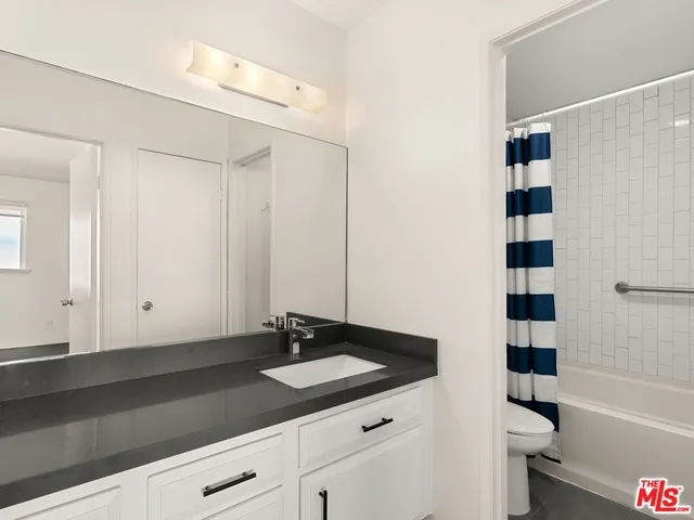 a bathroom with a shower and a toilet