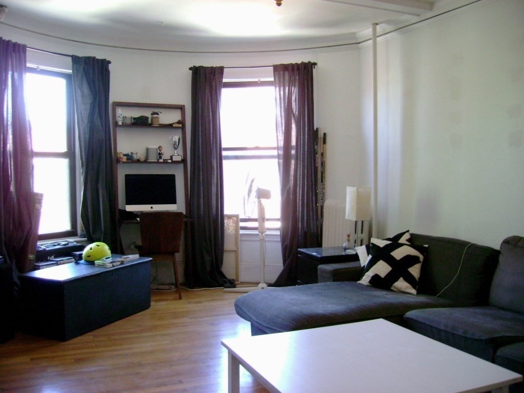924 Beacon Street, Unit 6 Boston, MA 02215 - Photo 6 of 28 a living room with furniture and a flat screen tv