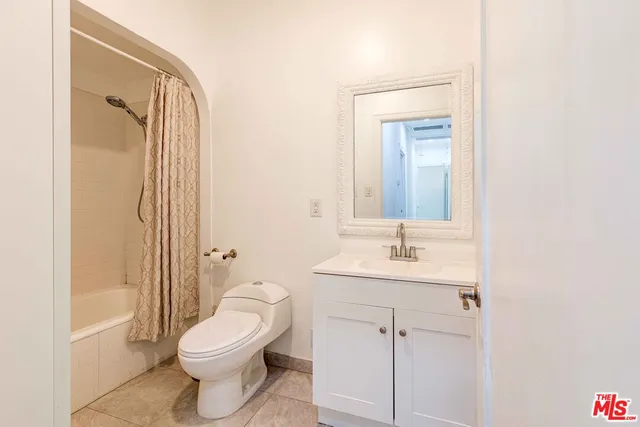 a bathroom with a toilet a sink and a mirror
