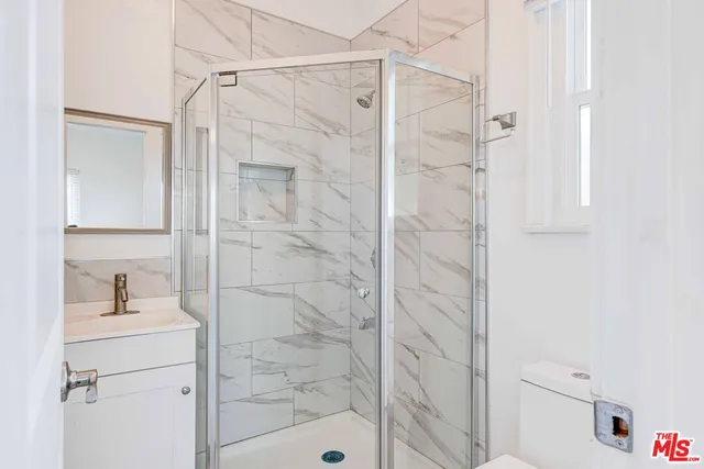 a bathroom with a shower and a sink