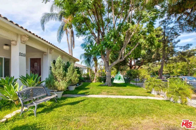 a backyard of a house with yard and outdoor seating