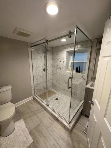 a bathroom with a shower and a toilet