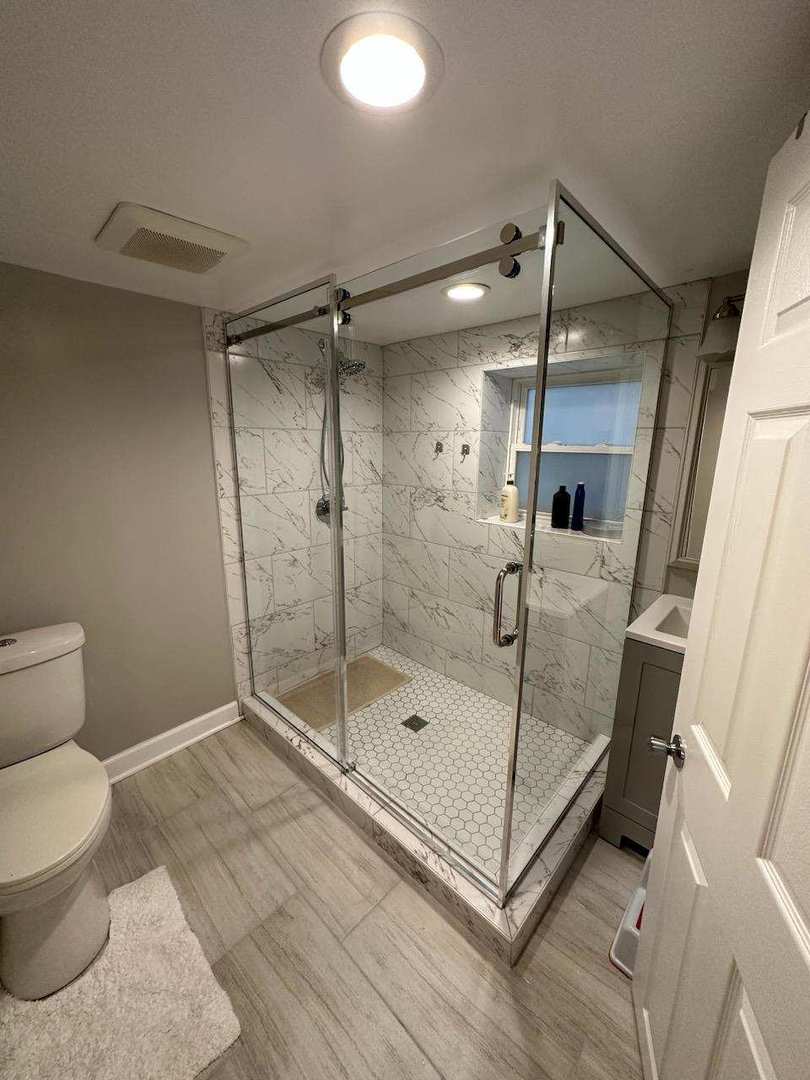 4247 West Melrose Street, Unit 1 Chicago, IL 60641 - Photo 6 of 6 a bathroom with a shower and a toilet