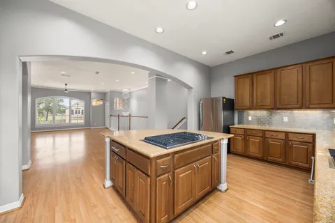 a bathroom with a granite countertop sink a large mirror and shower