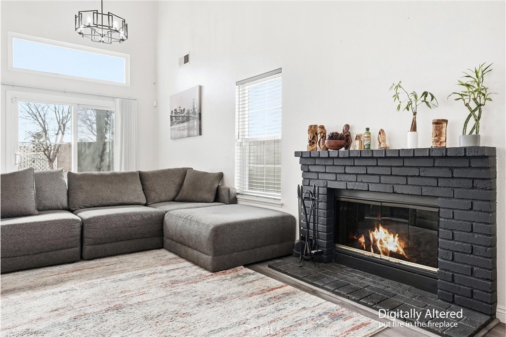 7639 Hillhurst Drive Riverside, CA 92508 - Photo 11 of 60 a living room with furniture a fireplace and a potted plant