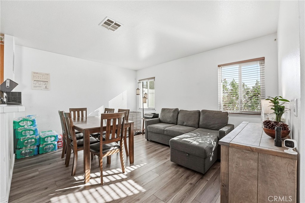 7639 Hillhurst Drive Riverside, CA 92508 - Photo 21 of 60 a living room with furniture wooden floor and floor to ceiling windows