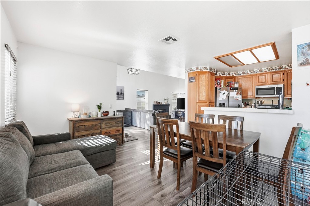 7639 Hillhurst Drive Riverside, CA 92508 - Photo 23 of 60 a living room with furniture a flat screen tv and kitchen view