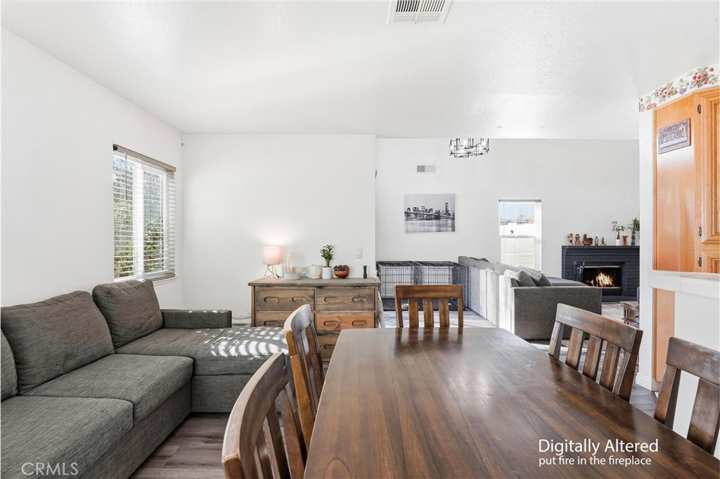 7639 Hillhurst Drive Riverside, CA 92508 - Photo 24 of 60 a living room with furniture a wooden floor and a window