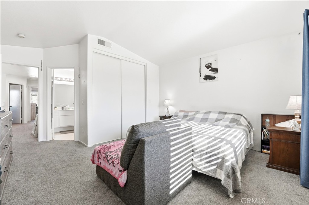 7639 Hillhurst Drive Riverside, CA 92508 - Photo 36 of 60 a bedroom with a bed and a chair