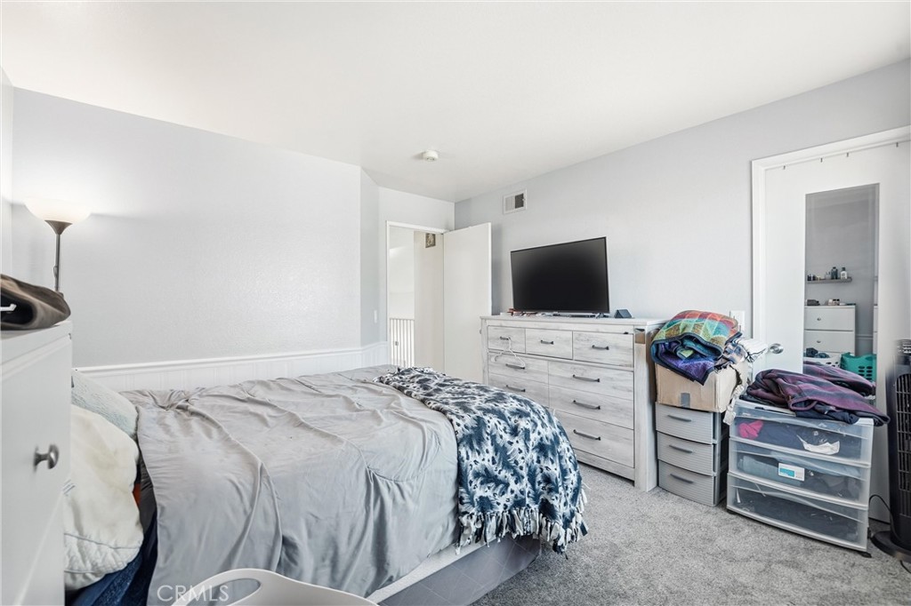 7639 Hillhurst Drive Riverside, CA 92508 - Photo 39 of 60 a bedroom with a bed and flat screen tv