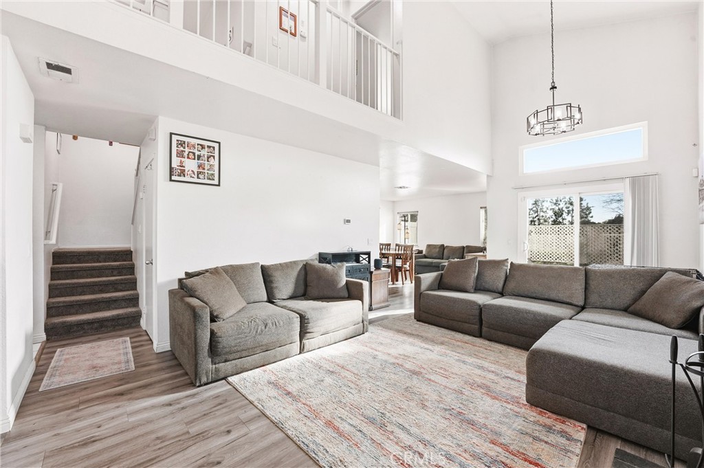 7639 Hillhurst Drive Riverside, CA 92508 - Photo 5 of 60 a living room with furniture a ceiling fan and a rug