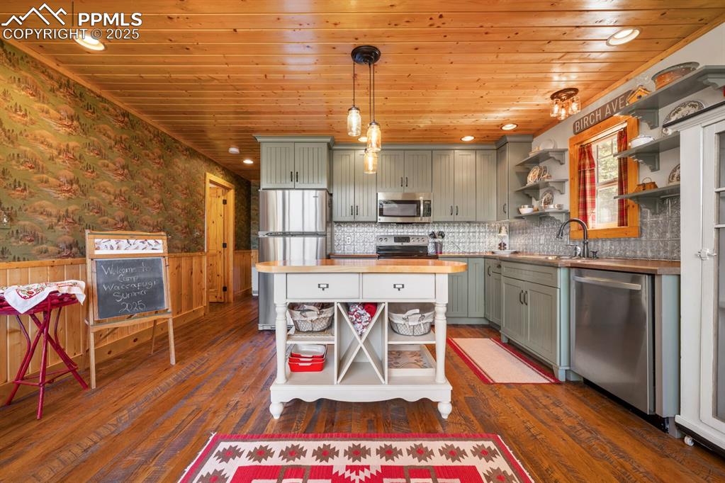 163 Wonder Trail Rye, CO 81069 - Photo 17 of 50 a kitchen with stainless steel appliances granite countertop a sink dishwasher a stove a refrigerator and cabinets with wooden floor