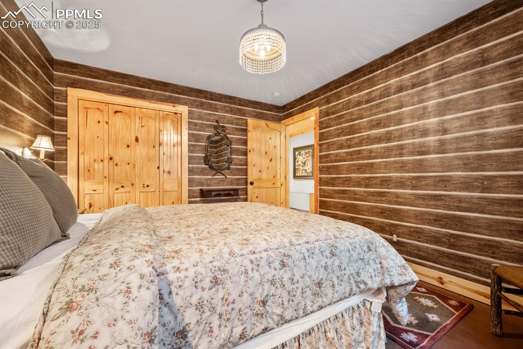 163 Wonder Trail Rye, CO 81069 - Photo 36 of 50 a bedroom with a bed and dresser with wooden floor