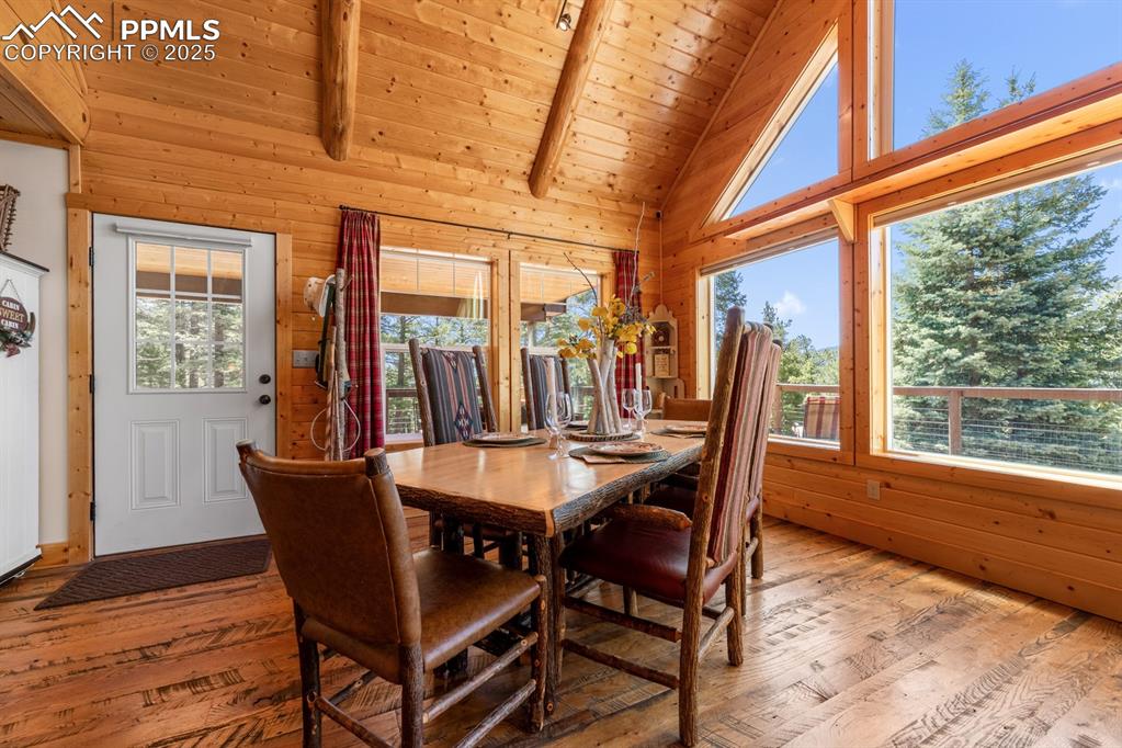 163 Wonder Trail Rye, CO 81069 - Photo 10 of 50 a dining room with furniture large windows and wooden floor