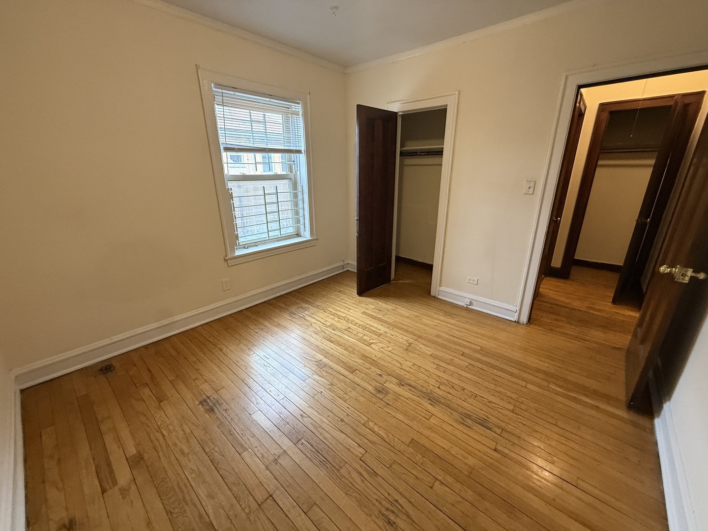 3152 North Linder Avenue, Unit 1 Chicago, IL 60641 - Photo 4 of 12 a view of an empty room with wooden floor and a window